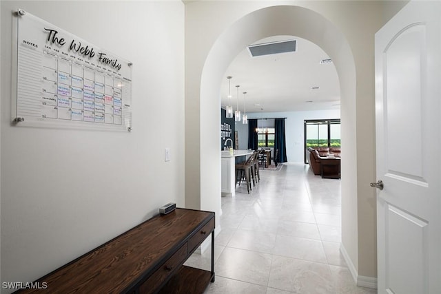 corridor featuring light tile patterned flooring