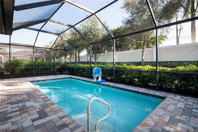 view of pool with a patio and a lanai