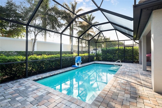 view of pool with a lanai and a patio area