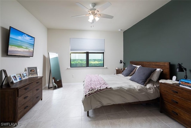 tiled bedroom featuring ceiling fan