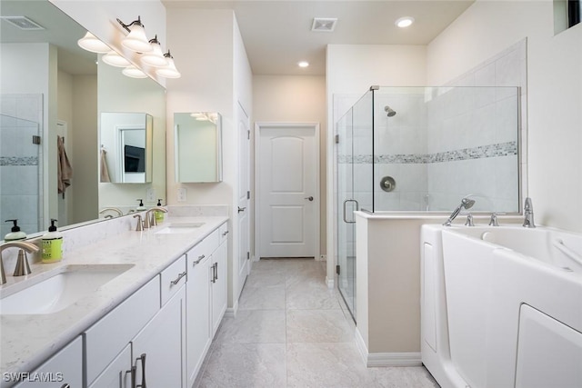 bathroom with tile patterned flooring, vanity, and walk in shower