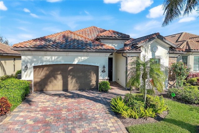 mediterranean / spanish-style house with a garage