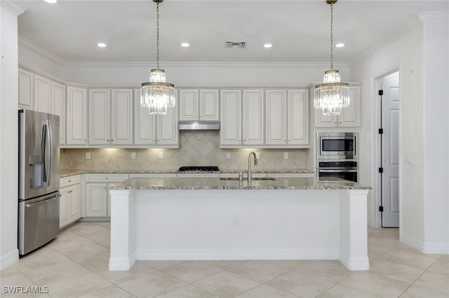 kitchen featuring sink, stainless steel appliances, light stone countertops, white cabinets, and a center island with sink