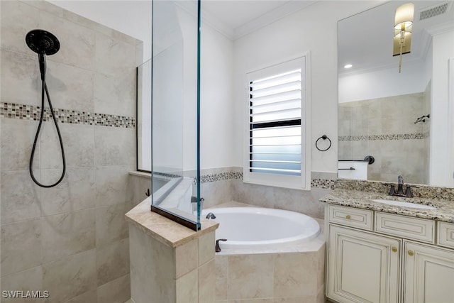 bathroom featuring crown molding, vanity, and separate shower and tub