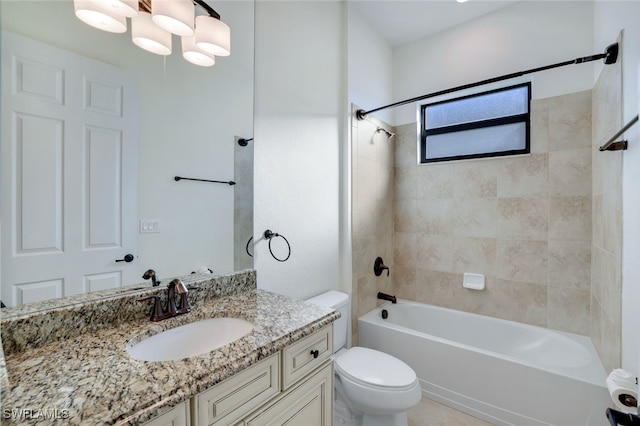 full bathroom with vanity, toilet, and tiled shower / bath combo