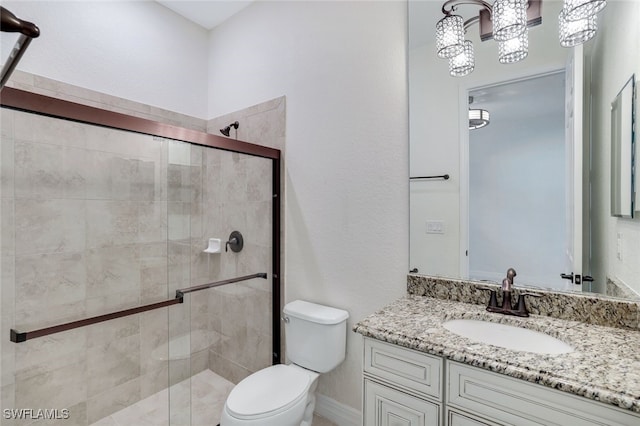 bathroom with vanity, toilet, and walk in shower