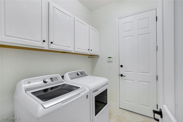 washroom featuring cabinets and washing machine and dryer