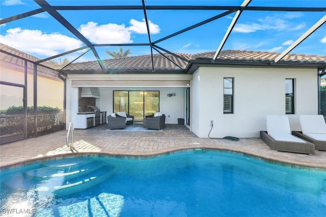 rear view of property featuring area for grilling, an outdoor hangout area, glass enclosure, and a patio area