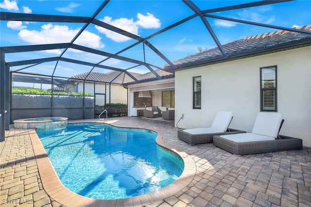 view of pool featuring a lanai, a patio, and an in ground hot tub