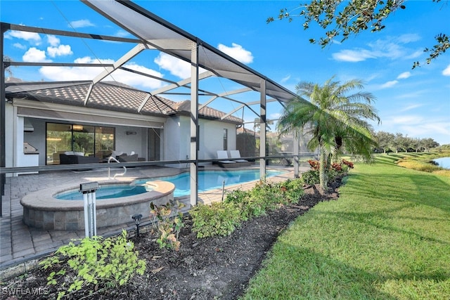 view of pool featuring a lanai, a lawn, a patio, and an in ground hot tub