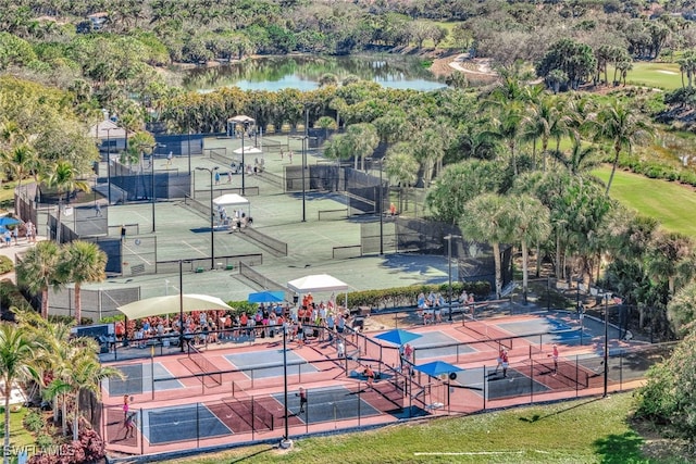 view of tennis court with a water view