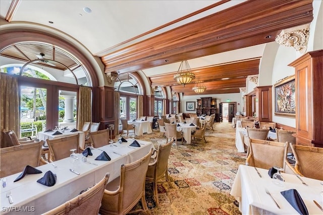 dining room featuring lofted ceiling, wooden ceiling, french doors, a chandelier, and ornate columns