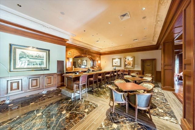 dining space with ornamental molding and hardwood / wood-style floors