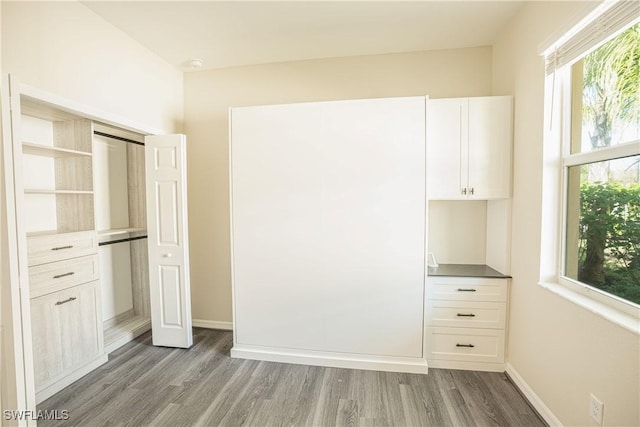 unfurnished bedroom featuring dark wood-type flooring and a closet