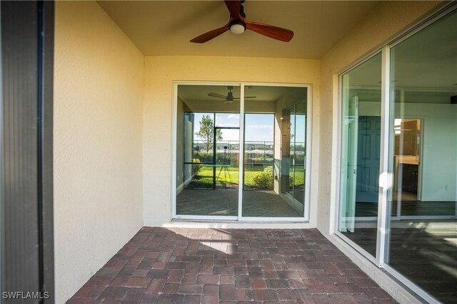 exterior space with ceiling fan