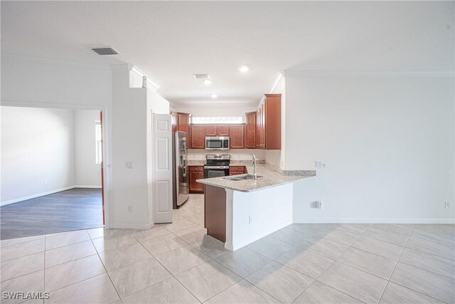 kitchen featuring light tile patterned flooring, appliances with stainless steel finishes, sink, kitchen peninsula, and crown molding