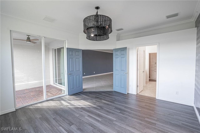 interior space with crown molding, dark hardwood / wood-style floors, and ceiling fan with notable chandelier