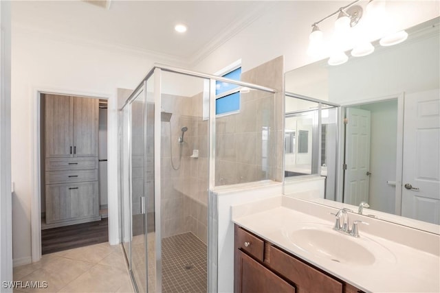 bathroom featuring an enclosed shower, crown molding, vanity, and tile patterned floors