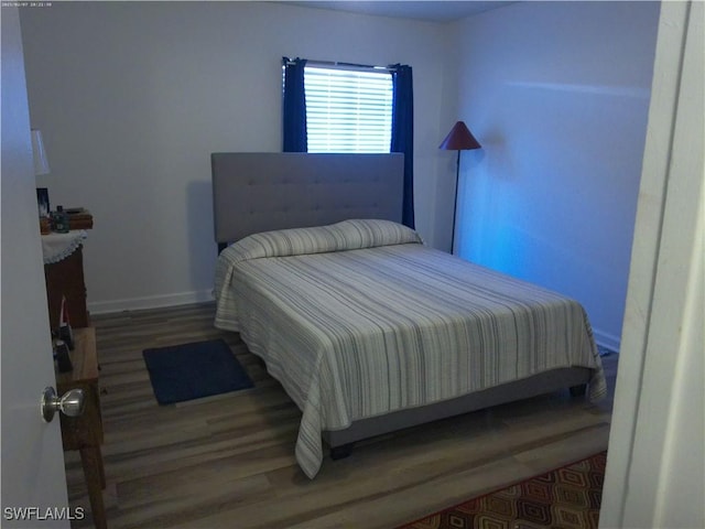 bedroom with wood-type flooring