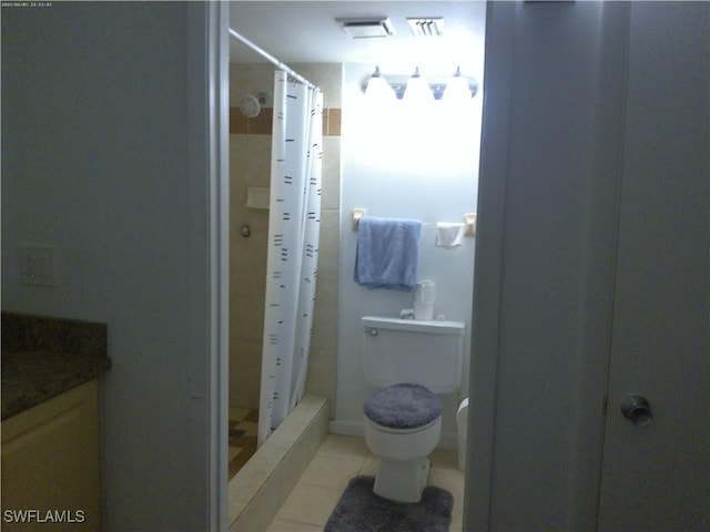 bathroom with walk in shower, tile patterned floors, vanity, and toilet