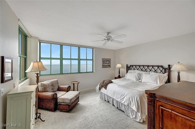 bedroom featuring multiple windows, ceiling fan, and light carpet