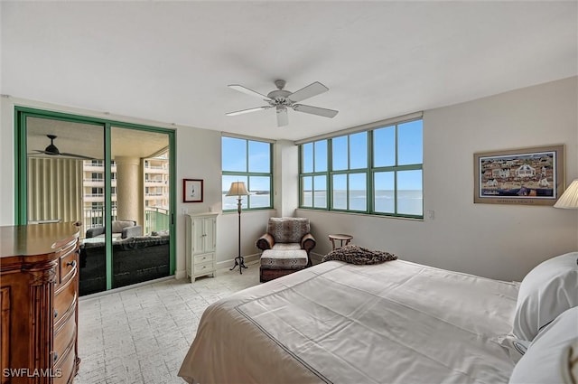 bedroom featuring a water view and ceiling fan