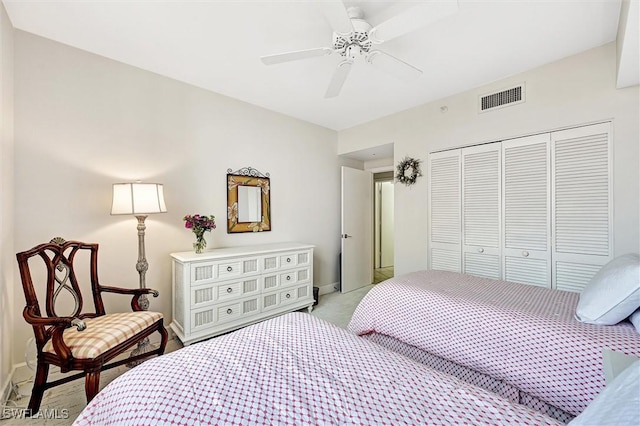 carpeted bedroom featuring a closet and ceiling fan