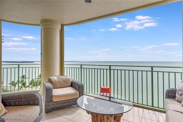 balcony with a water view and a beach view