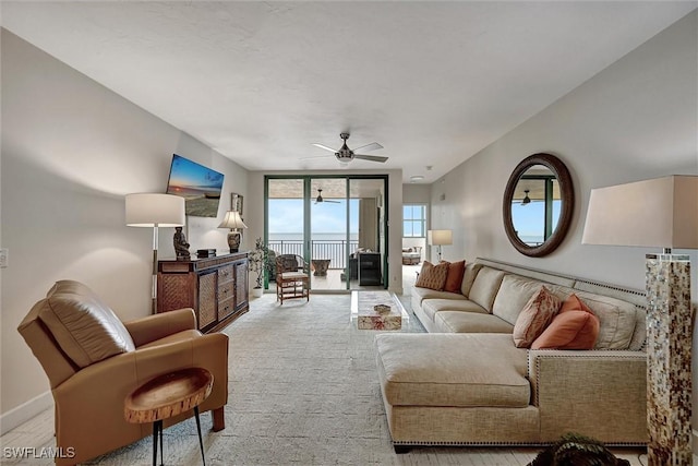 living room featuring expansive windows and ceiling fan