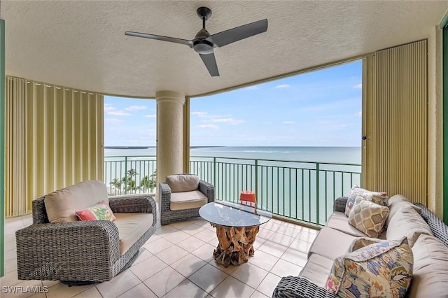 exterior space featuring an outdoor living space, ceiling fan, and a water view