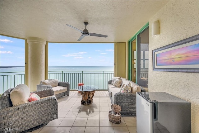 exterior space featuring a water view, a wealth of natural light, and ceiling fan