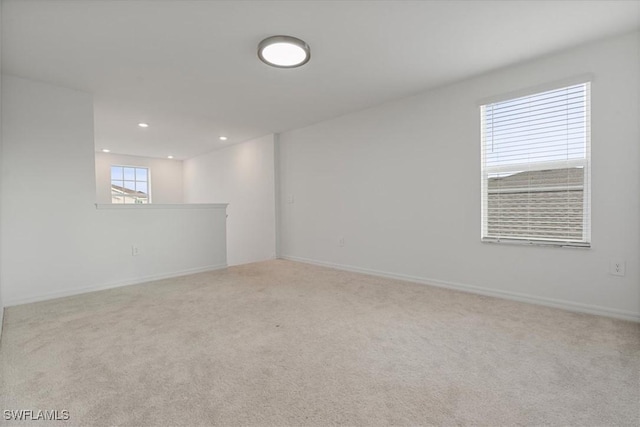 unfurnished room featuring light colored carpet