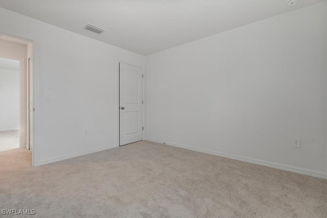 empty room featuring light colored carpet