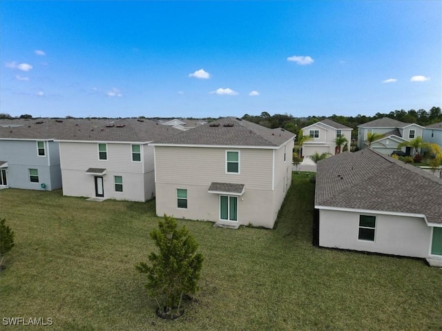 rear view of house with a lawn