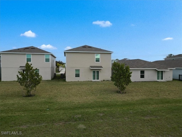 rear view of house with a yard