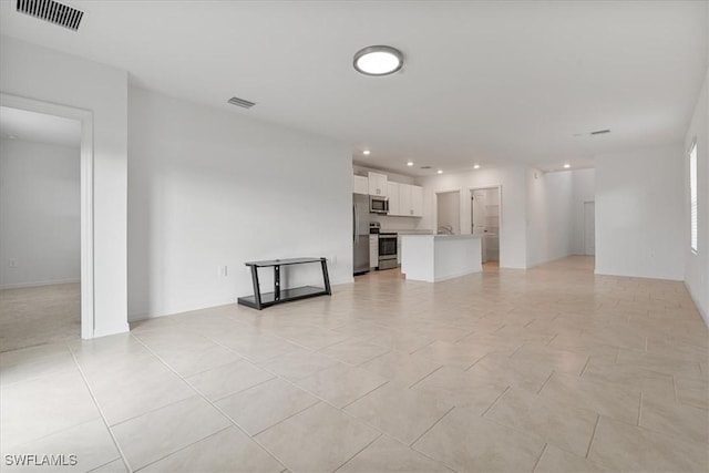 unfurnished living room featuring light tile patterned floors