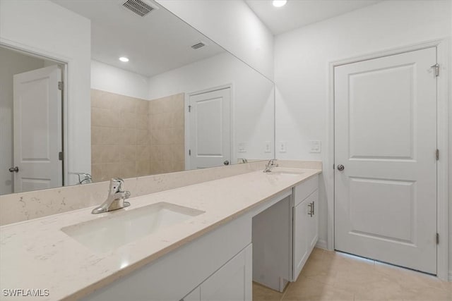 bathroom with tile patterned floors and vanity