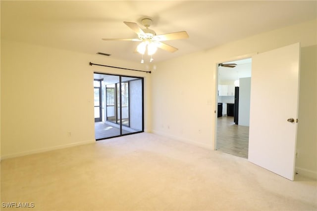 empty room with ceiling fan and carpet