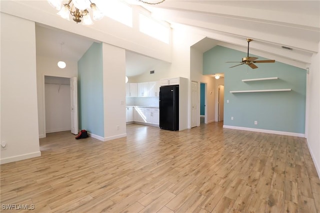 unfurnished living room with high vaulted ceiling, ceiling fan with notable chandelier, beam ceiling, and light hardwood / wood-style flooring