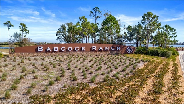 community / neighborhood sign featuring a water view