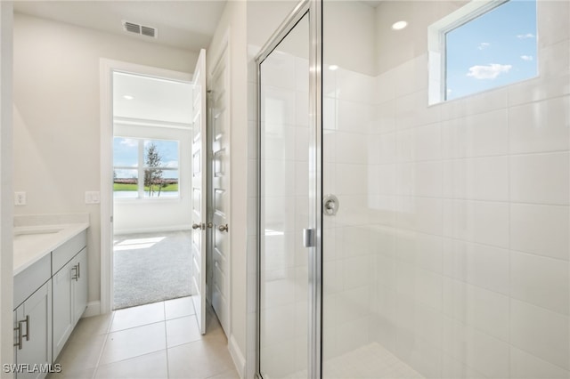 bathroom with tile patterned flooring, vanity, and an enclosed shower