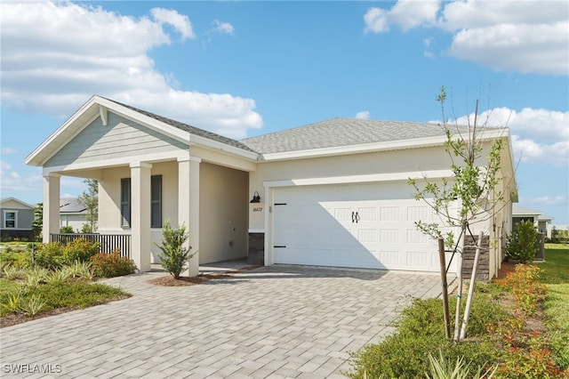 16672 Expedition Ct, Punta Gorda, FL 33982 - view of front of property with stucco siding, a garage, decorative driveway, and a porch