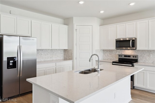 16672 Expedition Ct, Punta Gorda, FL 33982 - kitchen featuring stainless steel appliances, a sink, recessed lighting, white cabinets, and backsplash