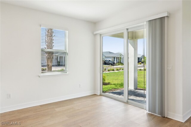 16672 Expedition Ct, Punta Gorda, FL 33982 - unfurnished room with wood finished floors, plenty of natural light, and baseboards