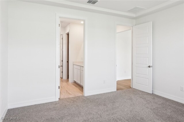 16672 Expedition Ct, Punta Gorda, FL 33982 - unfurnished bedroom featuring light colored carpet, connected bathroom, and baseboards