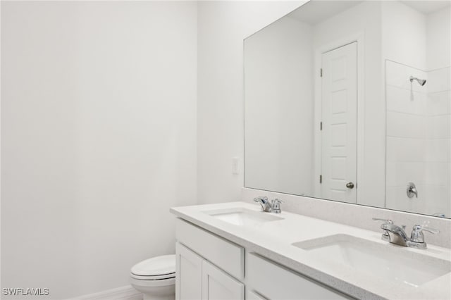 16672 Expedition Ct, Punta Gorda, FL 33982 - bathroom featuring double vanity, toilet, a shower, and baseboards
