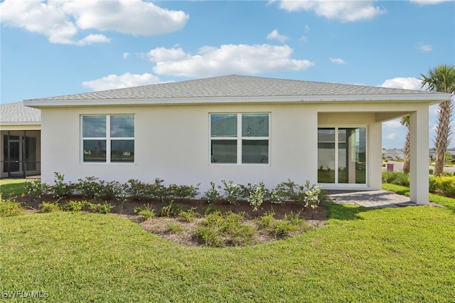 16672 Expedition Ct, Punta Gorda, FL 33982 - rear view of property featuring stucco siding, a lawn, a sunroom, and roof with shingles