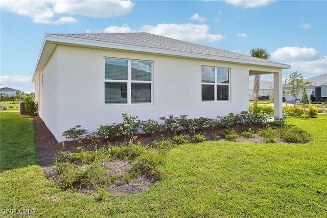 16672 Expedition Ct, Punta Gorda, FL 33982 - view of property exterior featuring a lawn and stucco siding