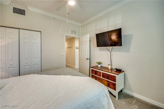 carpeted bedroom featuring crown molding, a closet, and ceiling fan