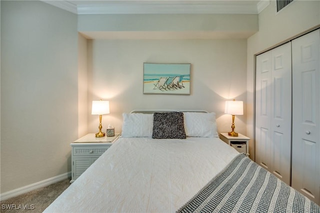 bedroom with ornamental molding, a closet, and carpet flooring